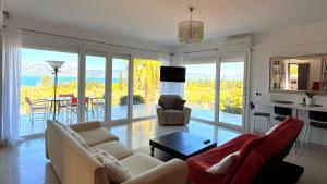 a living room with a couch and chairs and a table at View 2 bedrooms in Loukísia