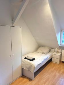 a small bedroom with a bed and a cabinet at Monteurs- und Ferienwohnung Miltenberg in Miltenberg