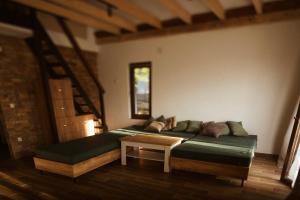 a living room with a couch and a table at Hotel Cider&Squash garden haus, Grncarska 6, Prnjavor in Prnjavor