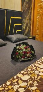 a bed with a bunch of flowers on it at AL Imran villa in Lahore +2 photos