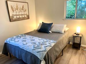a bedroom with a bed with a blue blanket on it at 4 Bed Ranch-Fire Pit-Pet & Kid Friendly-King Bed-Arcade in Columbus