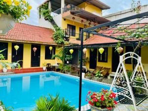 a villa with a swimming pool in front of a house at Phong Nha Ecolodge Homestay in Phong Nha