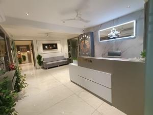 a lobby of a hotel with a reception desk at Hotel Royal Sky in Gandhinagar