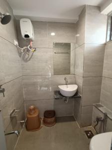 a bathroom with a sink and a toilet at Hotel Royal Sky in Gandhinagar