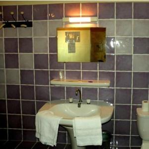 a bathroom with a sink with towels on it at Hotel l'Oronge in Saint-Jean-du-Gard