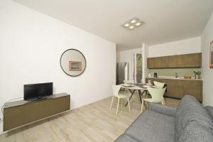 a living room with a couch and a table at Appartamenti Pratone in Garda