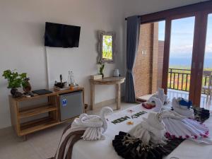 a bedroom with two swans on a bed with a balcony at Paradisehill Nusa Penida Resort in Klungkung
