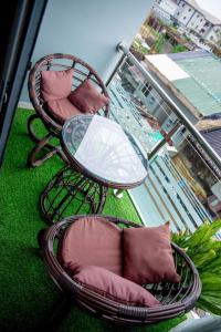 two chairs and a table on a balcony at WHITNEY LUXURY APARTMENTs in Lekki