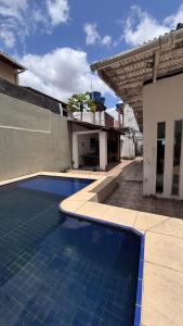 a swimming pool in front of a house at Casa para Cop 30 in Belém