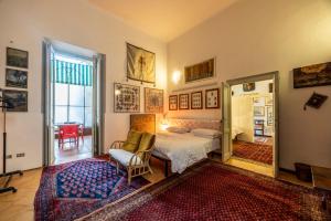 a bedroom with a bed and a chair in a room at Charme e storia apartment in Brescia center in Brescia