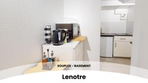 a kitchen with a coffee maker on a counter at Les appartements du Général Uhrich - Proche Parlement in Strasbourg
