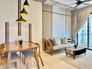 a living room with a table and a couch at Starview Bay 3pax Forest City in Gelang Patah