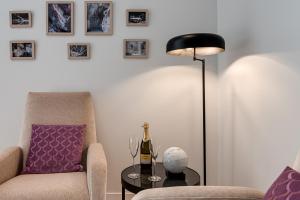 a living room with a chair and a lamp and a table at Marmo - Sweet Dreams in Florence in Florence +14 photos