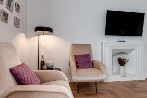 a living room with two chairs and a fireplace at Marmo - Sweet Dreams in Florence in Florence