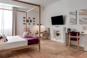 a bedroom with a bed and a desk and a tv at Marmo - Sweet Dreams in Florence in Florence
