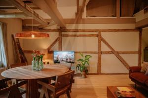 a living room with a wooden table and a couch at Design Hideaway On The Lauenburg Lake District in Schmilau