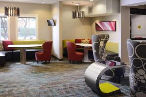 a waiting room with colorful chairs and tables at Sonesta ES Suites Dallas Central Expressway in Dallas +12 photos