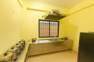 a kitchen with a sink and a row of pans at T1 Stay Manila-Near NAIA Manila Airport and PITX in Manila +90 photos
