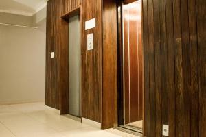 a row of wooden elevator doors in a building at Lider Hotel Ituiutaba in Ituiutaba