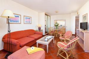 a living room with a couch and a table at Apartamentos Masaru in Puerto de la Cruz