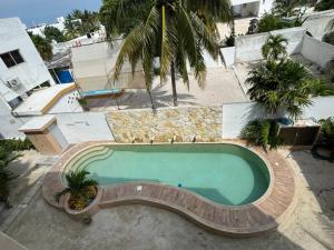 an overhead view of a swimming pool in a resort at Punta Arena Condominium in Chicxulub