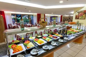 a buffet in a hotel with many plates of food at Apartamentos Masaru in Puerto de la Cruz