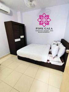 a bedroom with a bed with a pink cala sign on the wall at DEEJA Homestaycation Kuantan - Enjoy Private Pool by PG Management in Kuantan +6 photos