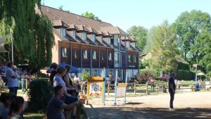 a group of people standing in front of a building at Pension Am Seeberg in Alt Zeschdorf