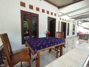 a table with a vase of flowers on top of it at Traveller Homestay in Narmada