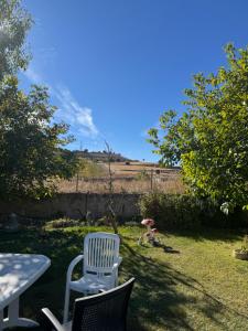 a table and two chairs and a table with an umbrella at Tamarón solar camping 