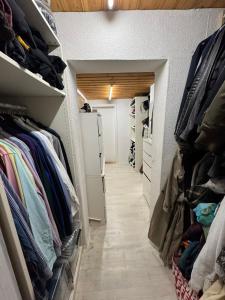 a walk in closet filled with lots of clothes at Ferienwohnung mit Terrasse in Hofheim am Taunus