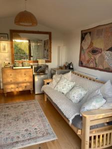 a bedroom with a large bed and a kitchen at Stunning views of Ynyshir & Southern Snowdonia in Machynlleth