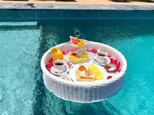 a table in the water with food on it in a swimming pool at Paradisehill Nusa Penida Resort in Klungkung