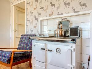 a kitchen with a stove with a pot on top at 3 bed property in Castletown CA416 in Castletown +23 photos