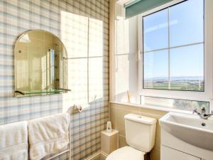 a bathroom with a toilet and a sink and a window at 3 bed property in Castletown CA416 in Castletown