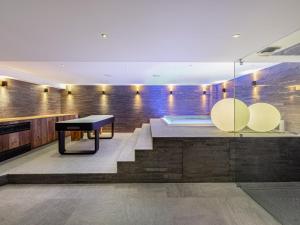 a room with stairs and a bench and a table at Chalet de luxe familial à Val d'Isère avec spa, proche des pistes et équipements premium - FR-1-567-72 in Val dʼIsère