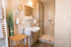 a bathroom with a sink and a shower at Hotel Gasthof Koch in Daaden +68 photos