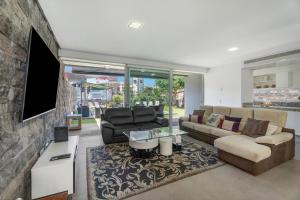 a living room with a couch and a tv at Villa Playa del Duque in Adeje
