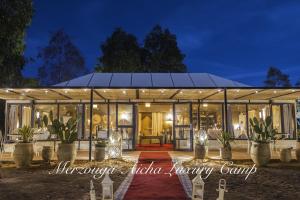 a greenhouse wedding at night with potted plants at Merzouga Aicha Luxury Camp in Merzouga