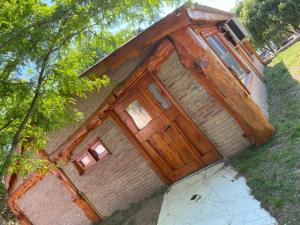 a building with a large wooden door on it at cabaña Mirador in Bialet Massé +1 photo