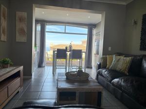 a living room with a couch and a table at Pinnacle Golf Villa 24-3 in DʼAlmeida +9 photos