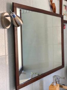 a mirror on a wall next to a sink at CityHouse Cagliari in Cagliari