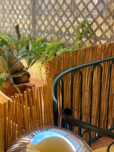a table with a chair and some plants and a fence at CityHouse Cagliari in Cagliari