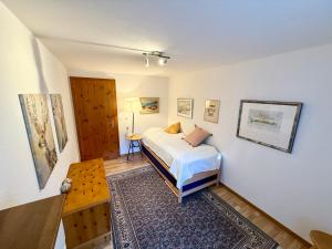 a bedroom with a bed and a table in it at Chalet Bärgheimet Saas-Fee in Saas-Fee