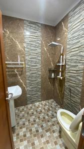 a bathroom with a toilet and a sink at Villa umaya 3 Bedroom Privat Pool in Paragajen +8 photos