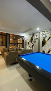 a pool table in a living room with couches at Villa umaya 3 Bedroom Privat Pool in Paragajen