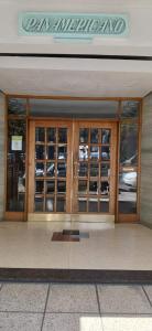 a store front with glass doors and a sign on it at Departamento a 2 cuadras de la playa in Mar del Plata