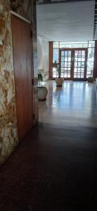 an empty lobby with two potted plants in a building at Departamento a 2 cuadras de la playa in Mar del Plata
