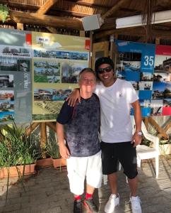 フロリアノポリスにある300mts da Praia de Jurerê - Asa Delta Jurerêの店の前で男性が男性を抱きしめている