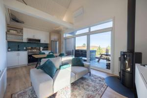 a living room with a couch and a kitchen at Spa and Mountain - Chalet OslO42 in Saint Come
